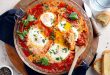 Shakshuka topped with peppers, olives, and feta