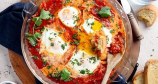 Shakshuka topped with peppers, olives, and feta